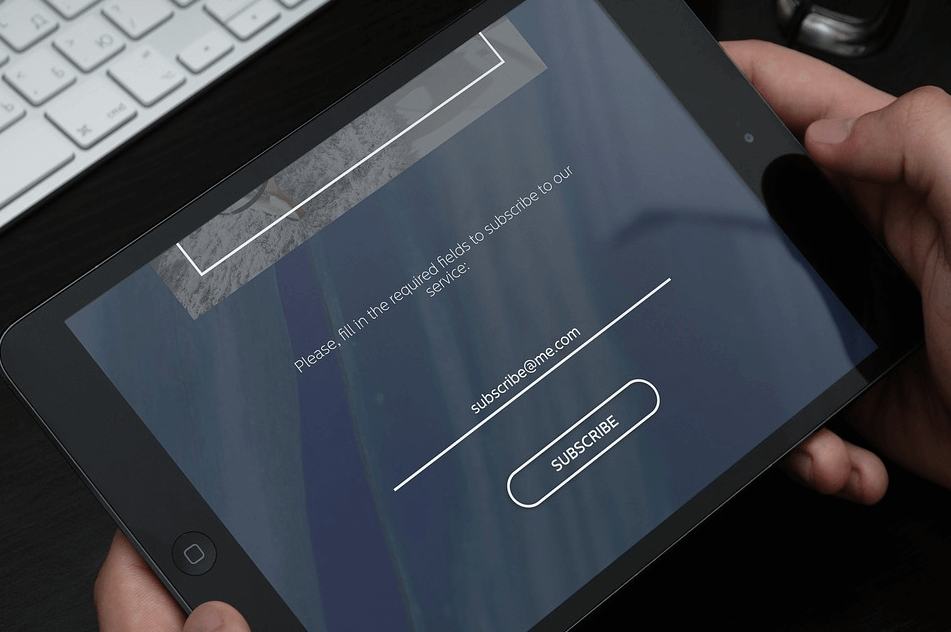 Person on tablet using contact forms.