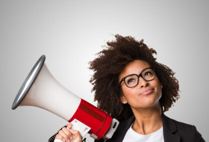Business woman demonstrates tone of voice in marketing using a megaphone