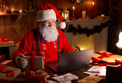 Santa looking at a laptop