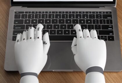 robotic AI hands are typing on a keyboard